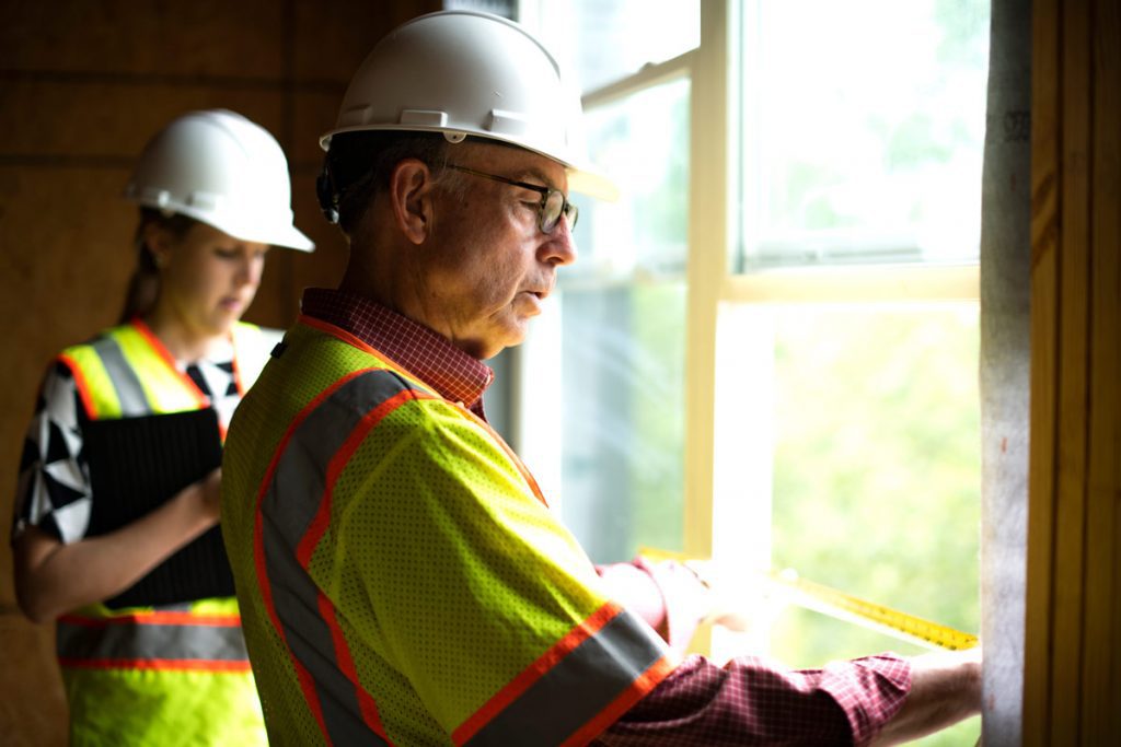 southeast-venture-home-our-credo two architects perform on-site measurements of a design construction project
